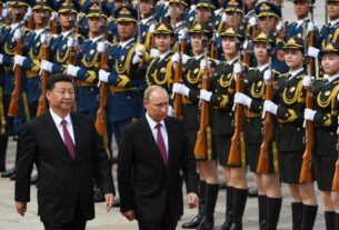 Putin analisa uma guarda de honra militar com Xi Jinping em Pequim em junho de 2018.